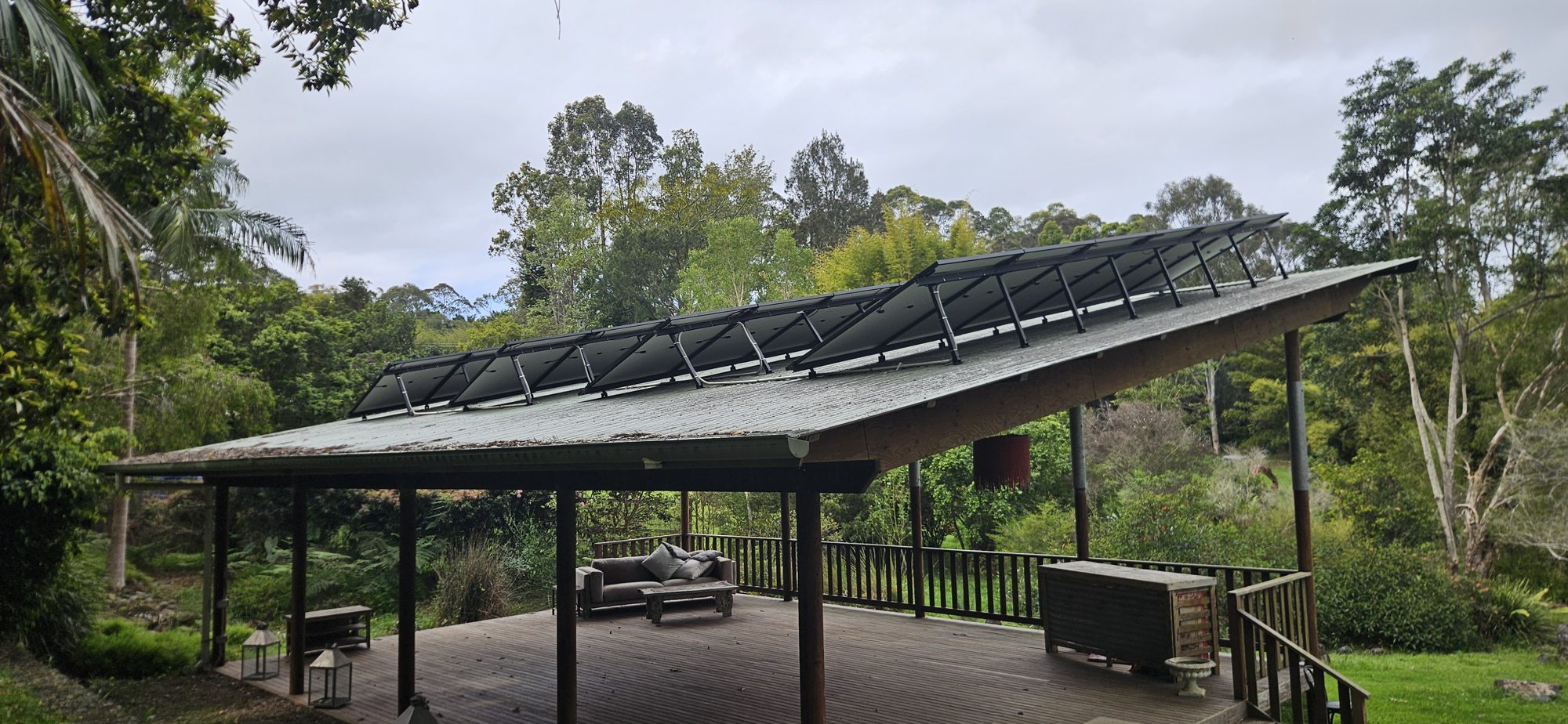 AIKO solar panels on north-facing tilt frames on an open pavilion roof at a Mullumbimby hinterland property AIKO solar panels on north-facing tilt frames on an open pavilion roof at a Mullumbimby hinterland property, installed by Sun Connect Solar