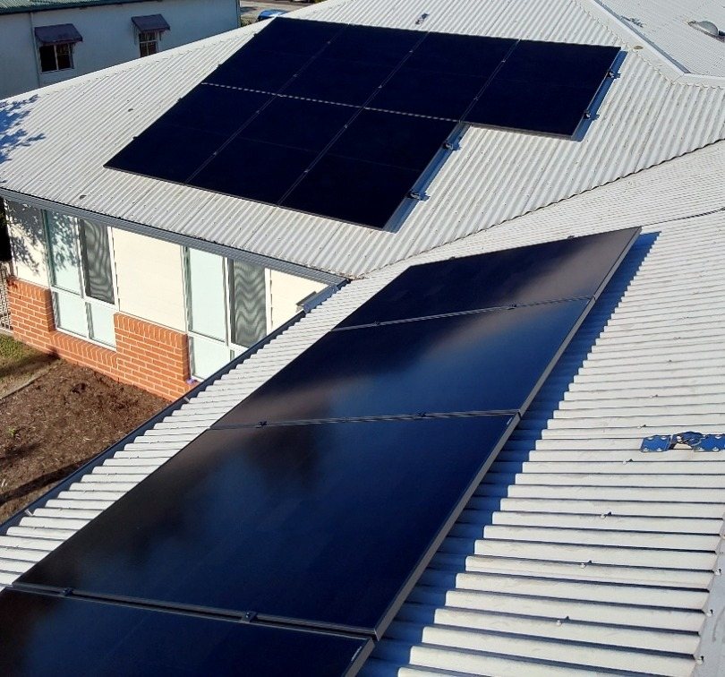All-black AIKO solar panels on a pale metal roof looking over Ballina All-black AIKO solar panels on a pale metal roof looking over Ballina, part of a solar install with a GoodWe inverter by Sun Connect Solar