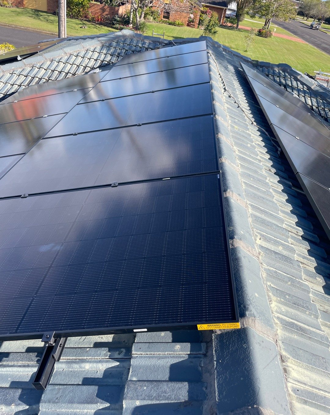 All-black Jinko solar panels on a grey concrete tile roof in Ballina, part of a solar and 16 kWh Sigenergy battery install by Sun Connect Solar