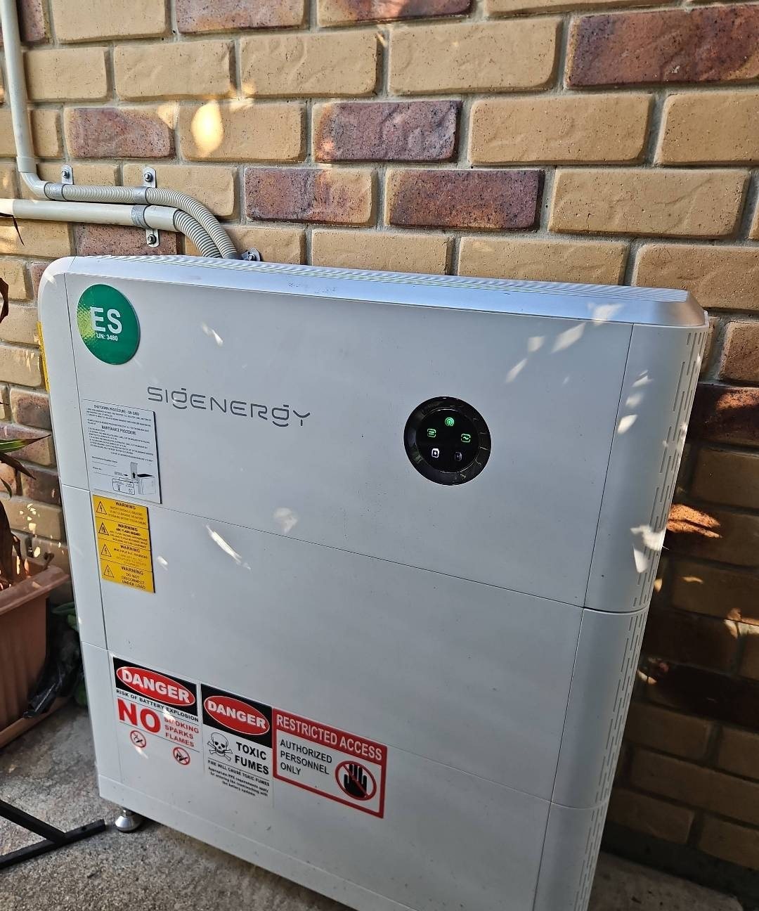 Sigenergy SigenStor 16 kWh battery with two modules against a brick wall in Bogangar Sigenergy SigenStor 16 kWh battery with two modules against a brick wall in Bogangar, installed by Sun Connect Solar