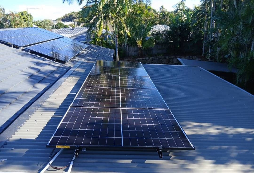 AIKO solar panels on a grey Colorbond roof among palms in Byron Bay AIKO solar panels on a grey Colorbond roof among palms in Byron Bay, part of a 10.45 kW solar and Sigenergy battery install by Sun Connect Solar