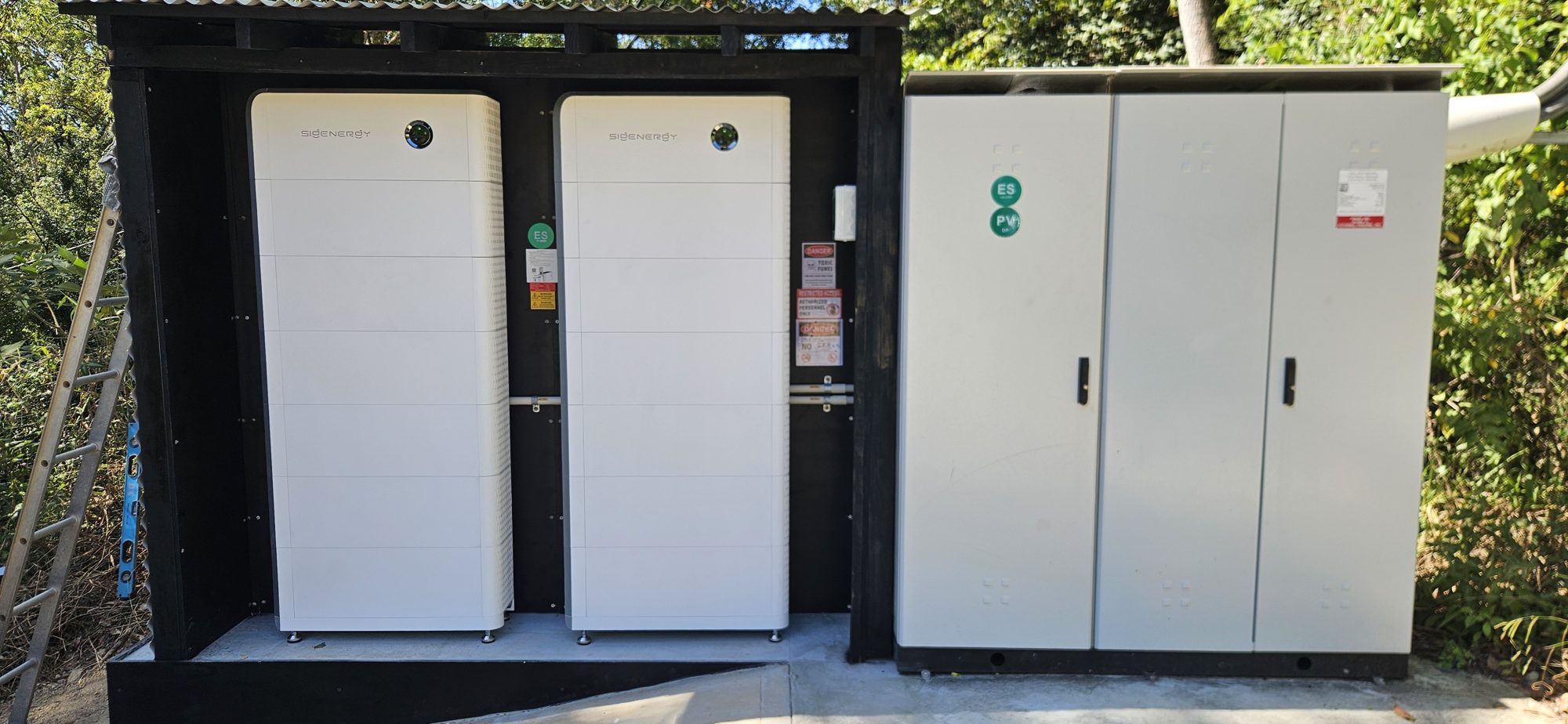 Two Sigenergy battery stacks beside large switchgear cabinets, a commercial-scale battery storage installation by Sun Connect Solar in the Northern Rivers NSW Two Sigenergy battery stacks beside large switchgear cabinets, a commercial-scale battery storage installation by Sun Connect Solar in the Northern Rivers NSW