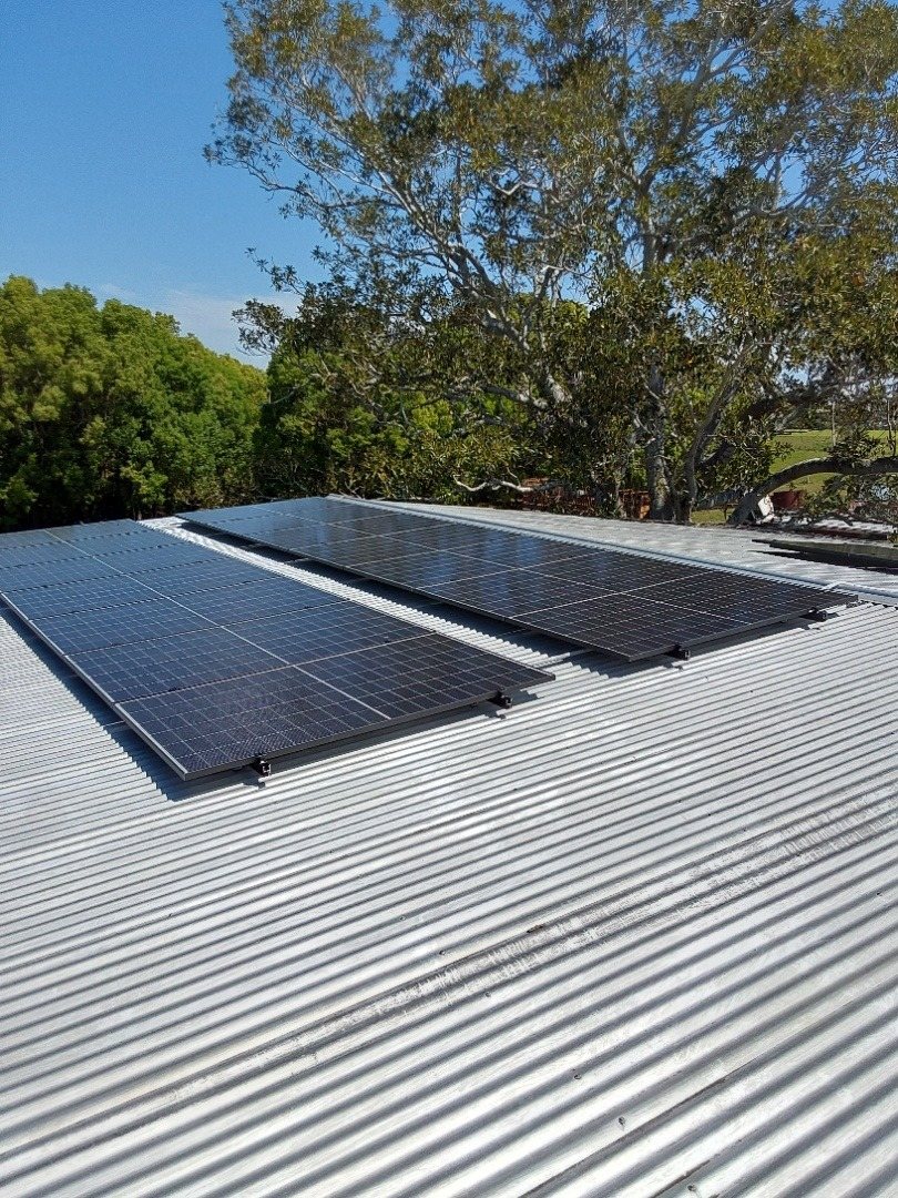 A 13.3 kW Jinko solar array on a low-pitched galvanised roof beside gum trees in the Coraki area A 13.3 kW Jinko solar array on a low-pitched galvanised roof beside gum trees in the Coraki area, installed by Sun Connect Solar