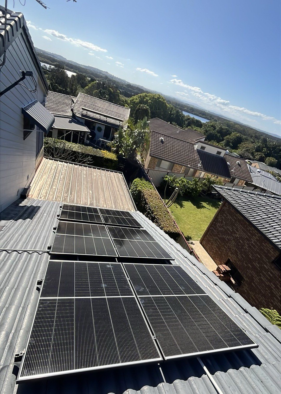 Jinko solar panels on a roof in East Ballina with the river in the distance, part of a 6.65 kW solar and Sigenergy battery install by Sun Connect Solar