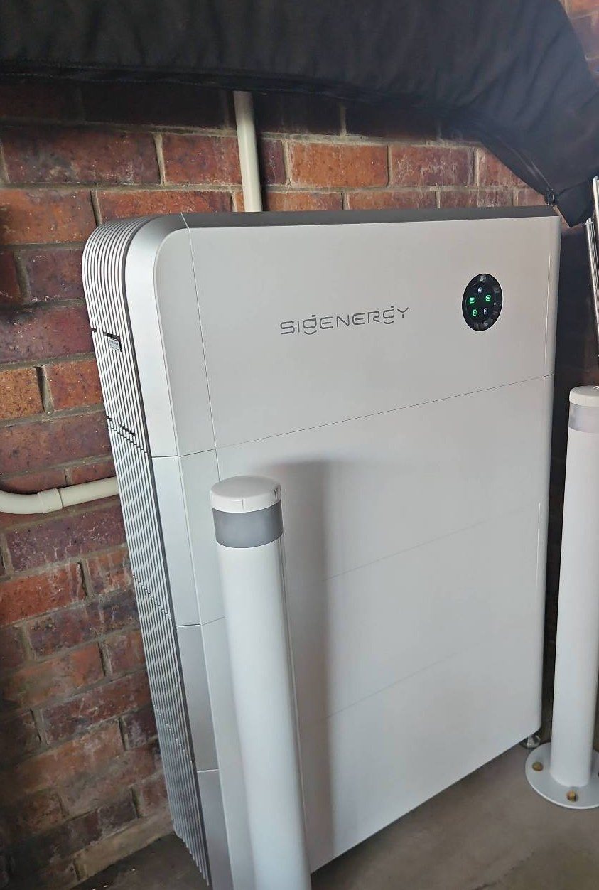 Sigenergy SigenStor 24 kWh battery with protective bollards against a brick wall in East Ballina, installed by Sun Connect Solar