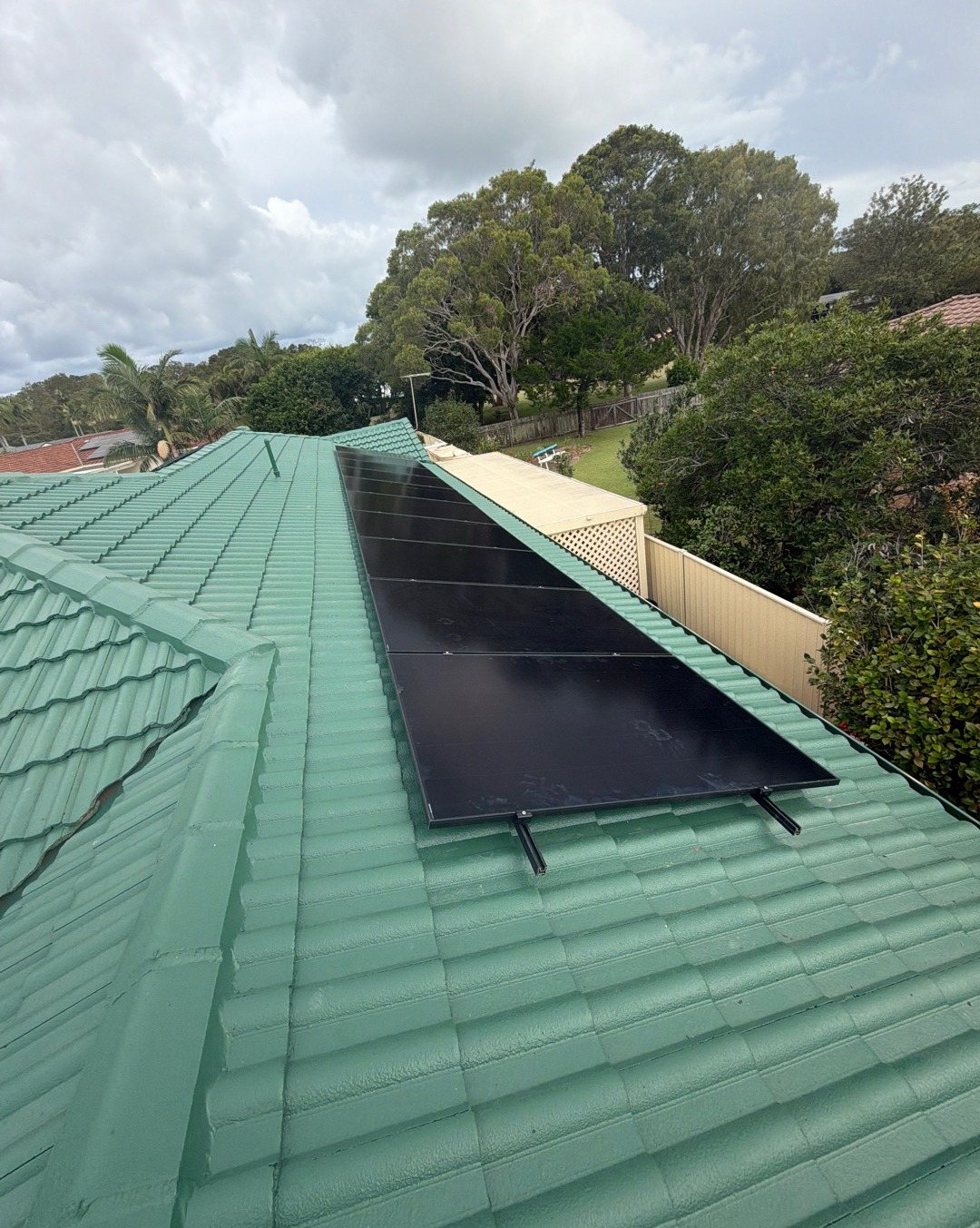 A single row of ten all-black AIKO solar panels on a green concrete tile roof in East Ballina A single row of ten all-black AIKO solar panels on a green concrete tile roof in East Ballina, installed by Sun Connect Solar