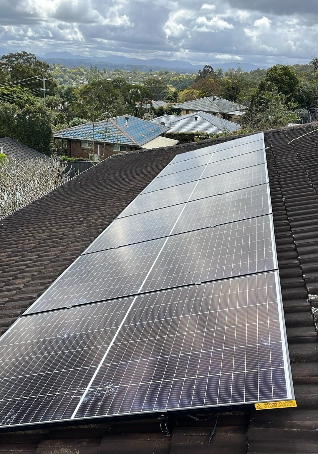 Jinko Tiger Neo III solar panels on a brown tile roof in Goonellabah with the hills behind Lismore in the distance Jinko Tiger Neo III solar panels on a brown tile roof in Goonellabah with the hills behind Lismore in the distance, part of a 9.18 kW solar and GoodWe battery install by Sun Connect Solar