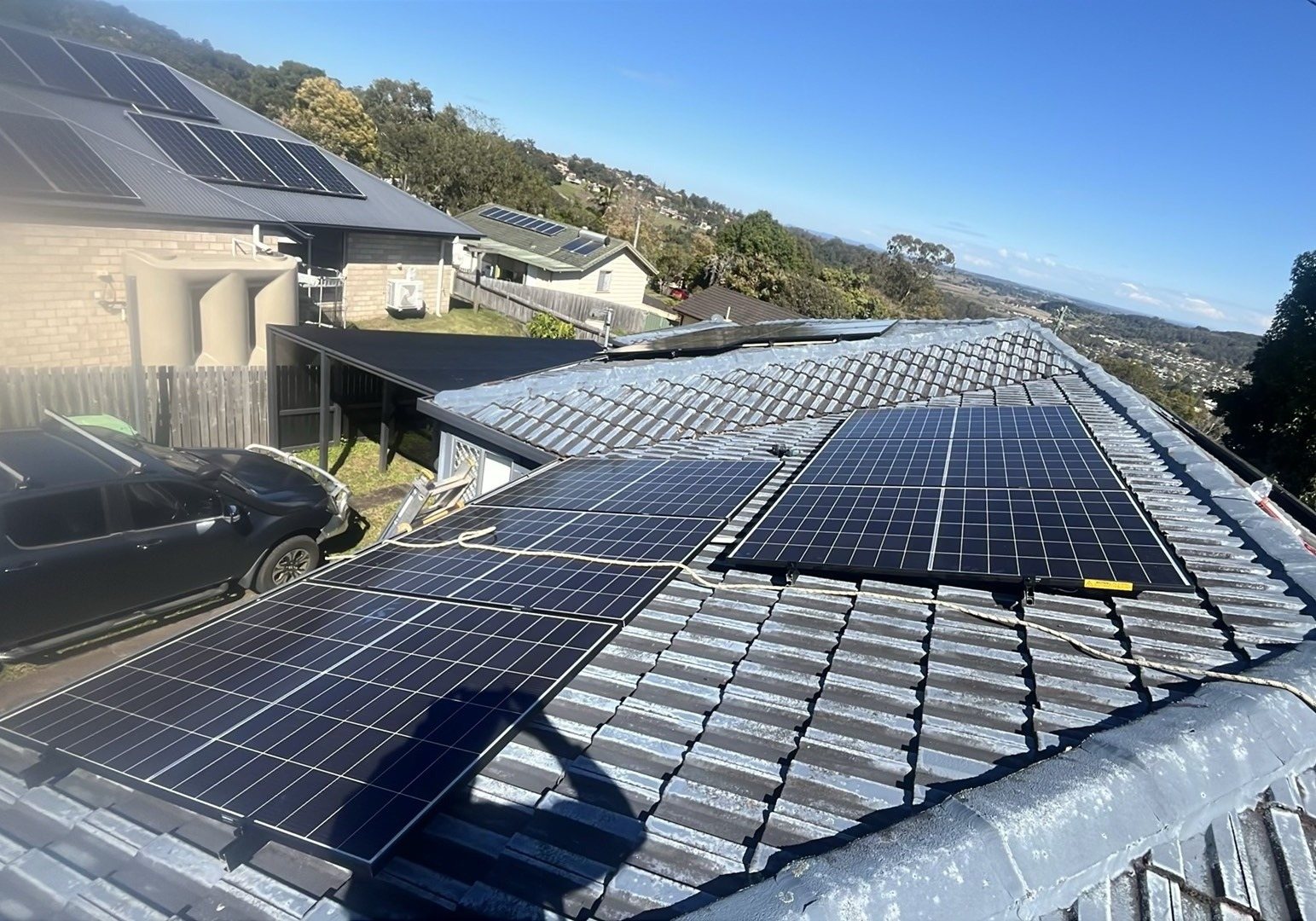 Trina solar panels on two faces of a tiled hip roof in Goonellabah looking over the suburb Trina solar panels on two faces of a tiled hip roof in Goonellabah looking over the suburb, installed by Sun Connect Solar