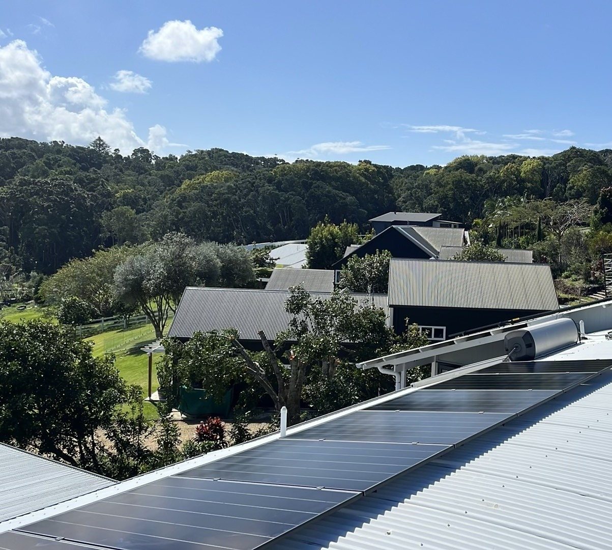 AIKO Neostar solar panels along a curved metal roof in Lennox Head AIKO Neostar solar panels along a curved metal roof in Lennox Head, looking over gardens and hinterland forest, part of an 8.33 kW solar and 18 kWh Sigenergy battery install by Sun Connect Solar