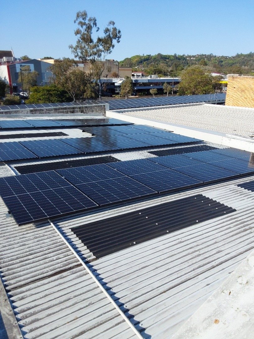 Jinko solar panels across several roof sections of a building in the Lismore town centre Jinko solar panels across several roof sections of a building in the Lismore town centre, installed by Sun Connect Solar