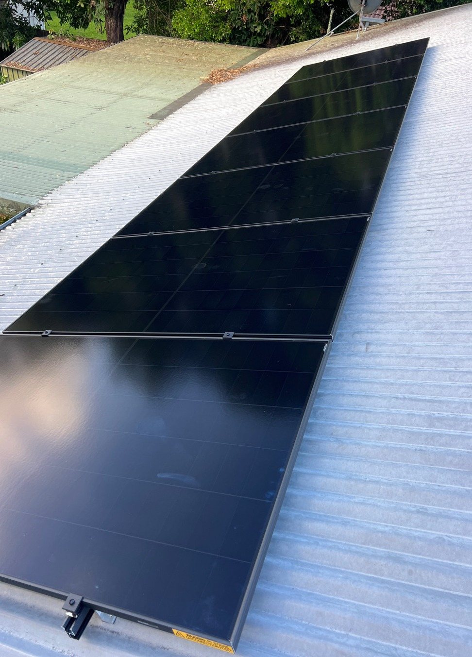A long run of all-black AIKO Neostar solar panels along a metal roof in Mullumbimby A long run of all-black AIKO Neostar solar panels along a metal roof in Mullumbimby, part of a 6.6 kW solar and 16 kWh Sigenergy battery install by Sun Connect Solar