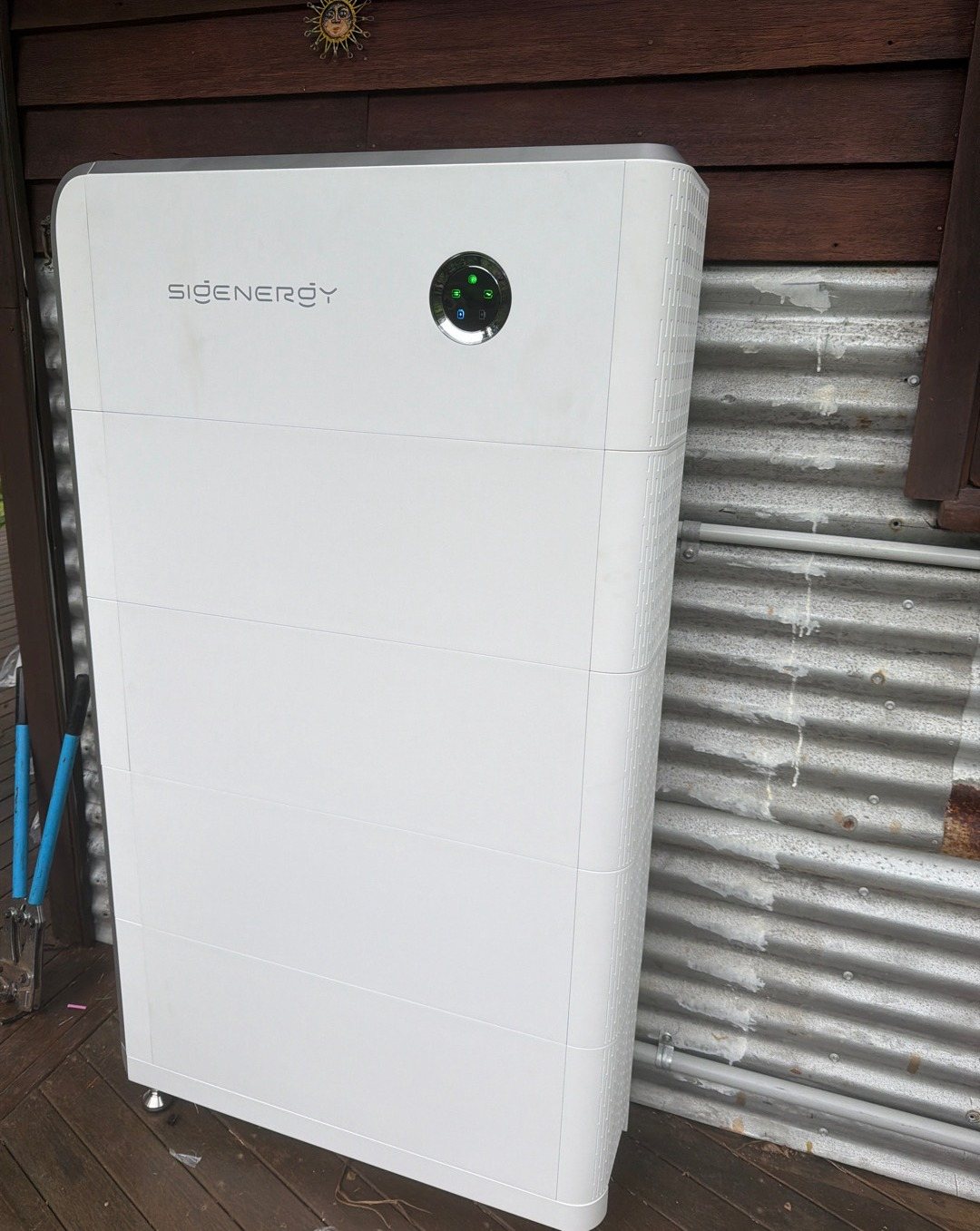 Sigenergy SigenStor battery Sigenergy SigenStor battery, about 32 kWh, on a timber deck against corrugated iron at Mullumbimby Creek, installed by Sun Connect Solar