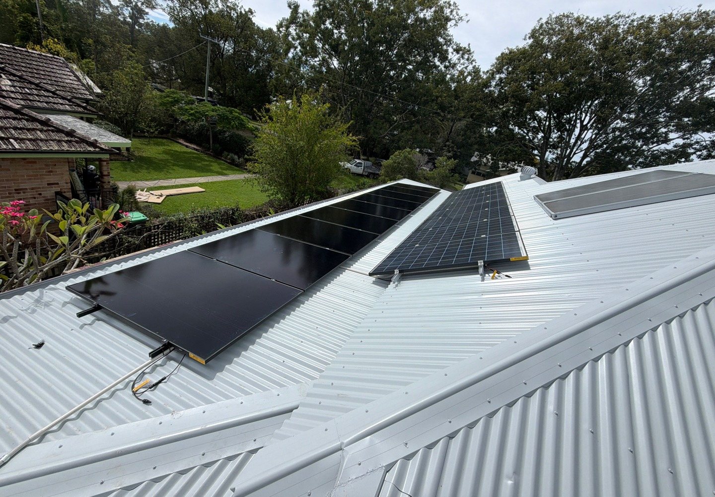 New all-black AIKO solar panels beside an older array on a metal roof in Mullumbimby New all-black AIKO solar panels beside an older array on a metal roof in Mullumbimby, installed by Sun Connect Solar