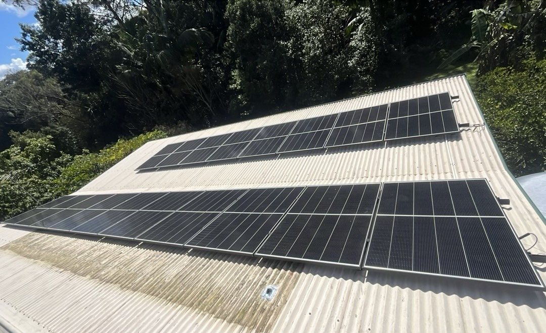 Jinko solar array of 18 panels on a corrugated roof among tall trees at Nimbin Jinko solar array of 18 panels on a corrugated roof among tall trees at Nimbin, installed by Sun Connect Solar