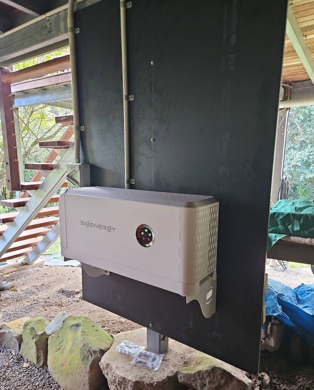 Sigenergy 10 kW hybrid inverter on a formply board under a raised house at Nimbin Sigenergy 10 kW hybrid inverter on a formply board under a raised house at Nimbin, installed by Sun Connect Solar
