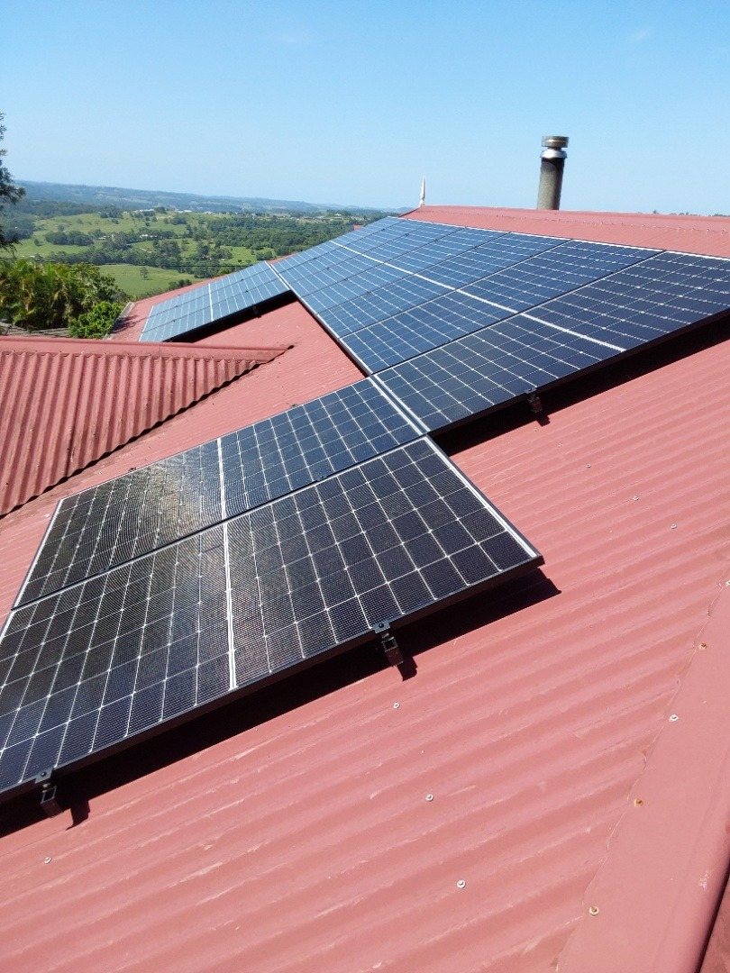 Seraphim solar panels on a red metal roof above farmland at Richmond Hill near Lismore Seraphim solar panels on a red metal roof above farmland at Richmond Hill near Lismore, installed by Sun Connect Solar