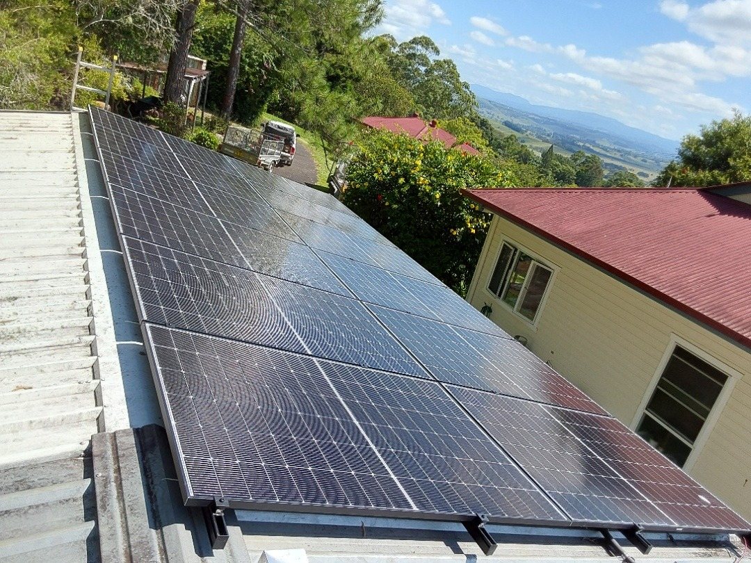 Seraphim solar panels on a metal roof at Richmond Hill with a wide view over the valley towards Lismore Seraphim solar panels on a metal roof at Richmond Hill with a wide view over the valley towards Lismore, part of a Sungrow battery install by Sun Connect Solar