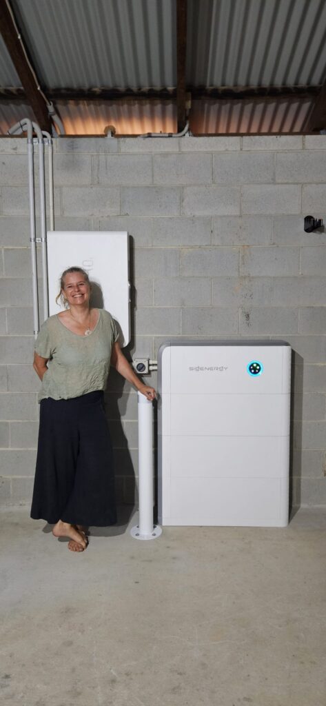 Mullumbimby area customer beside a new 24 kWh Sigenergy battery with bollard and Gateway, installed by Sun Connect Solar