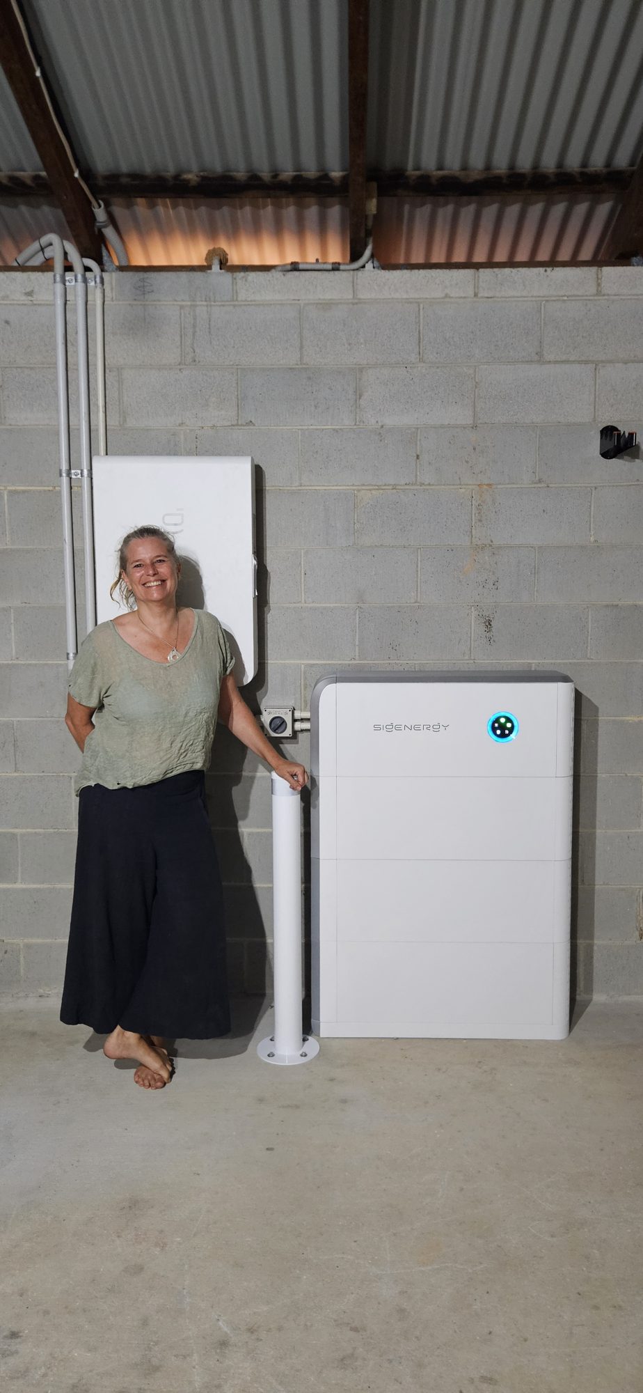 Mullumbimby area customer beside a new 24 kWh Sigenergy battery with bollard and Gateway, installed by Sun Connect Solar