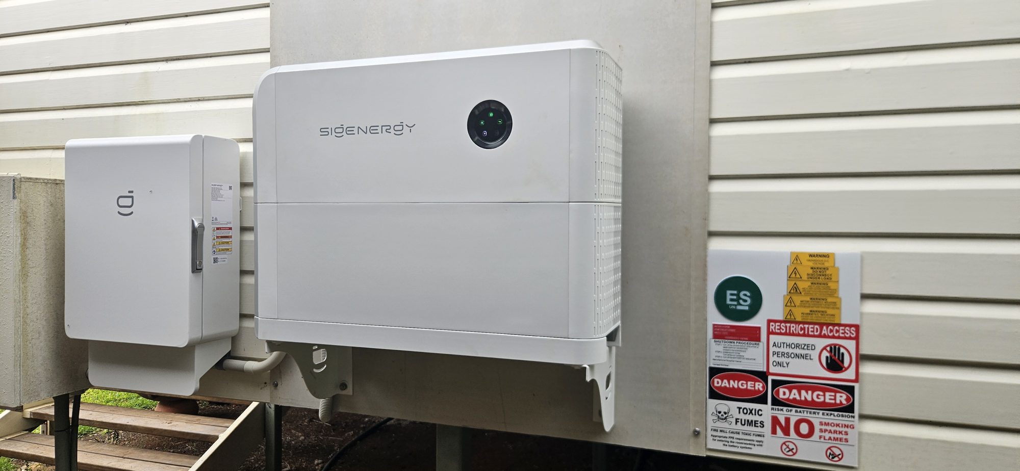 Sigenergy battery with restricted access and battery safety signage beside it, installed by Sun Connect Solar near Lismore
