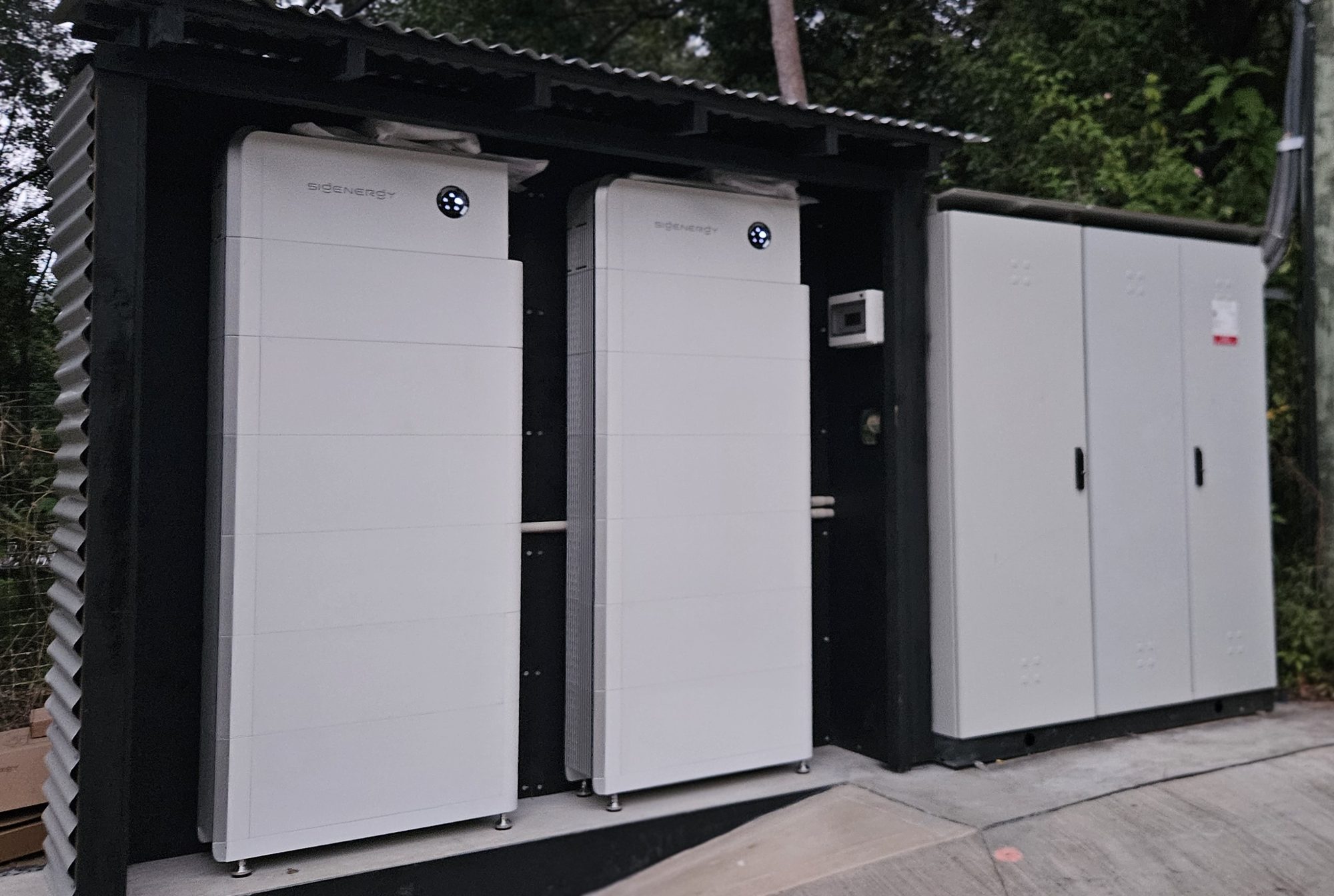 Two Sigenergy SigenStor battery stacks in a purpose-built battery shed beside the main switchboard at a Murwillumbah area farm, commercial battery install by Sun Connect Solar