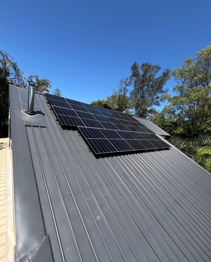 AIKO solar array on a grey Colorbond roof under blue sky in South Golden Beach, installed by Sun Connect Solar