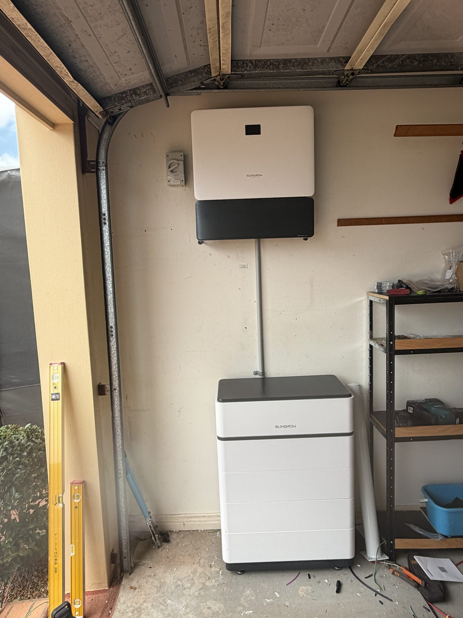 Sungrow battery and hybrid inverter on a garage wall, installed by our own electricians in the Northern Rivers