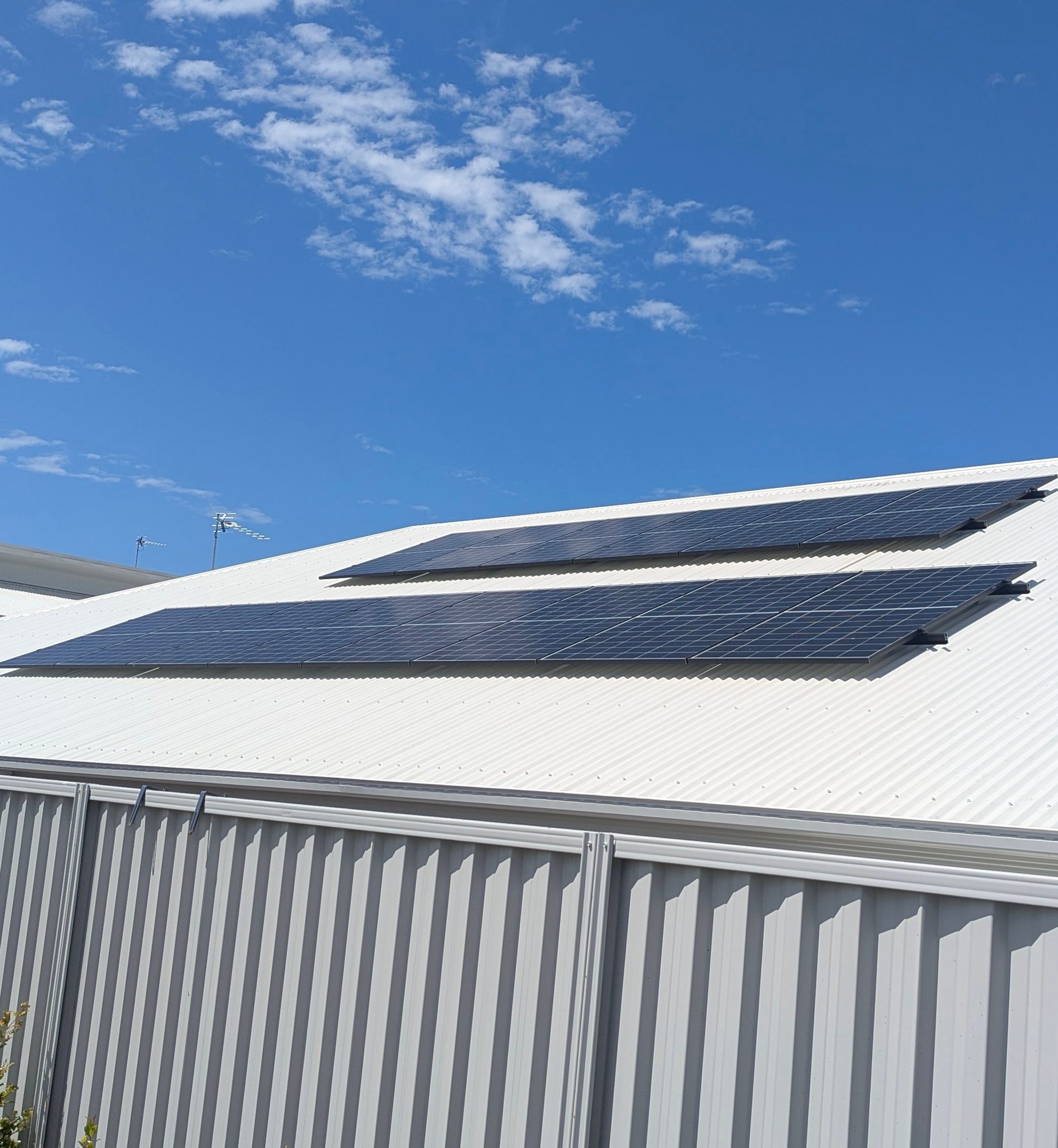 Trina solar panels in two rows on a metal roof at a Mullumbimby home, installed by Sun Connect Solar